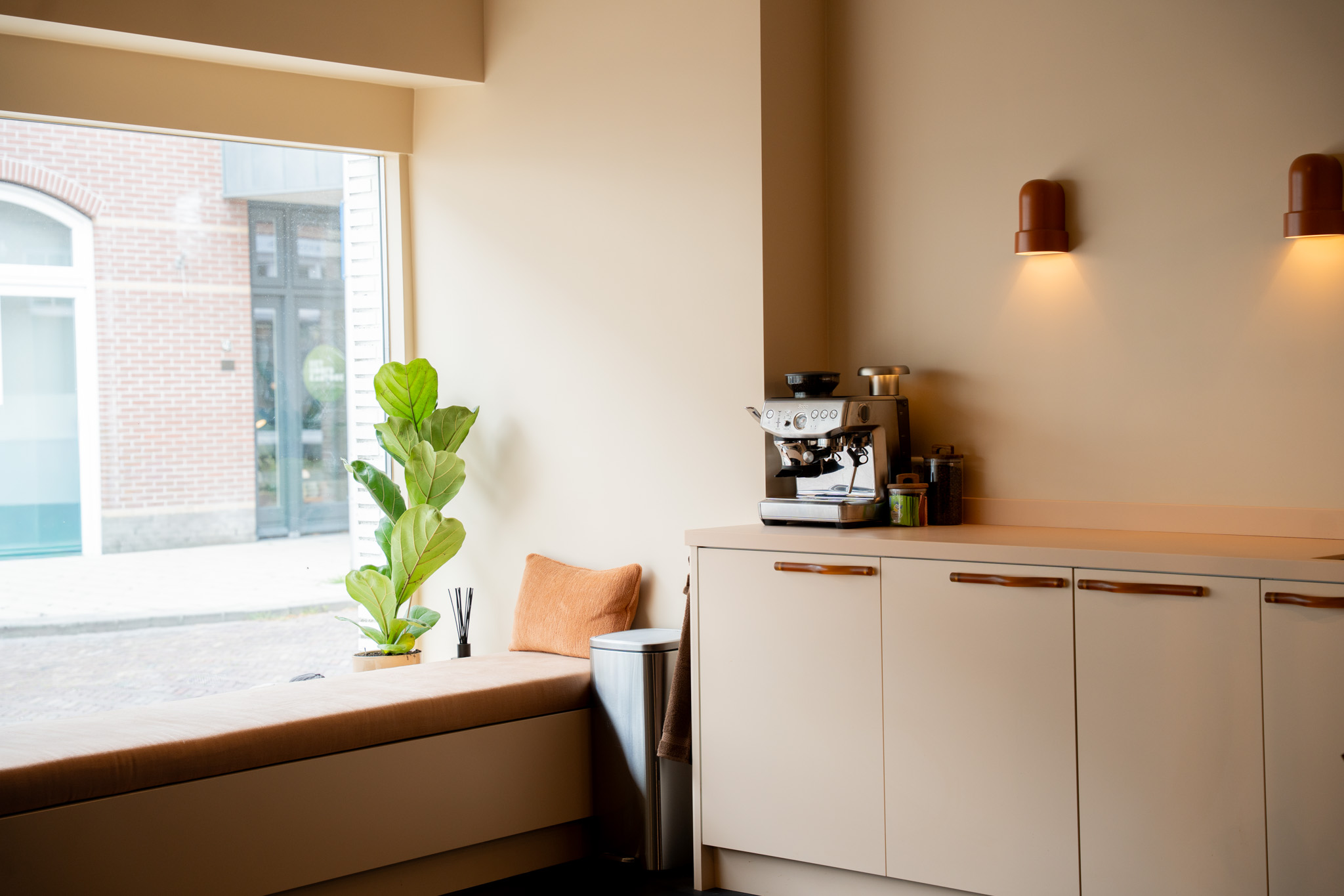 freddies studio bussum vensterbank met plant en kussen naast keukenblok met espressomachine